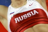 A Russian athlete celebrates winning gold at the 2004 Olympic Games.