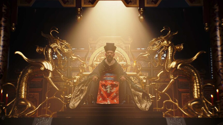 A scene from the movie Mulan with Jet Li as a Chinese emperor sitting on a golden throne