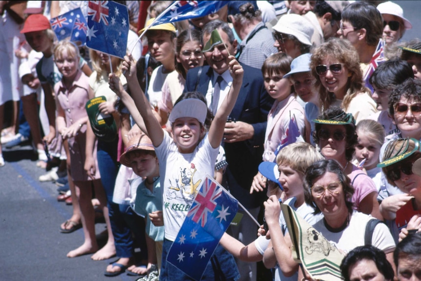 Children wave flags at America's Cup victory celebrations in Perth, 1983.