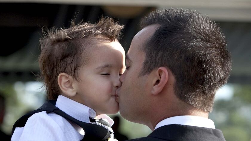 Sapper Darren Smith kisses his son, Mason, on his wedding day