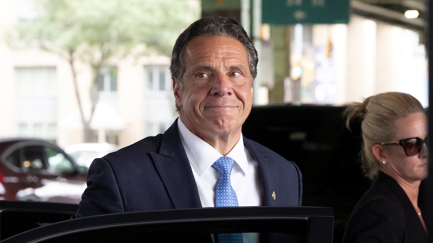 Andrew Cuomo steps out of a car.
