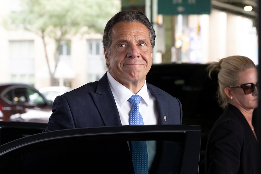 Andrew Cuomo steps out of a car.