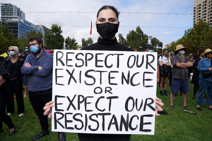 A woman holds a placard at Adelaide's March 4 Justice rally.