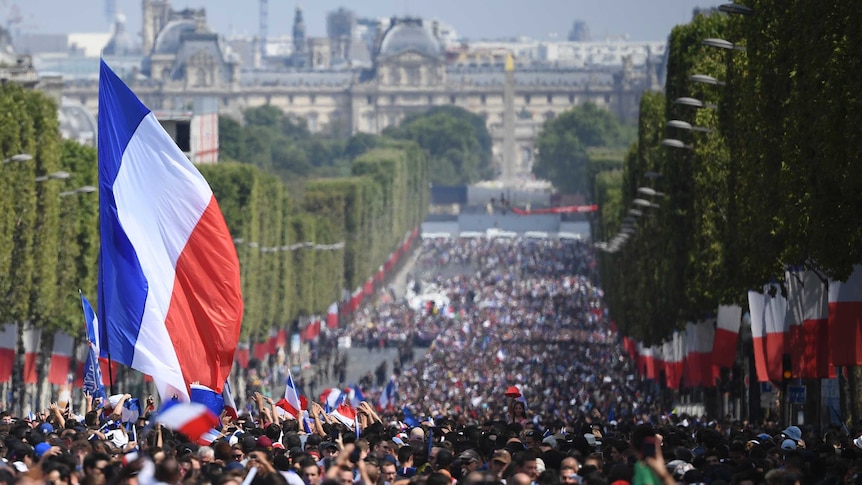 Fans wave french flags on the Champs-Elysees.