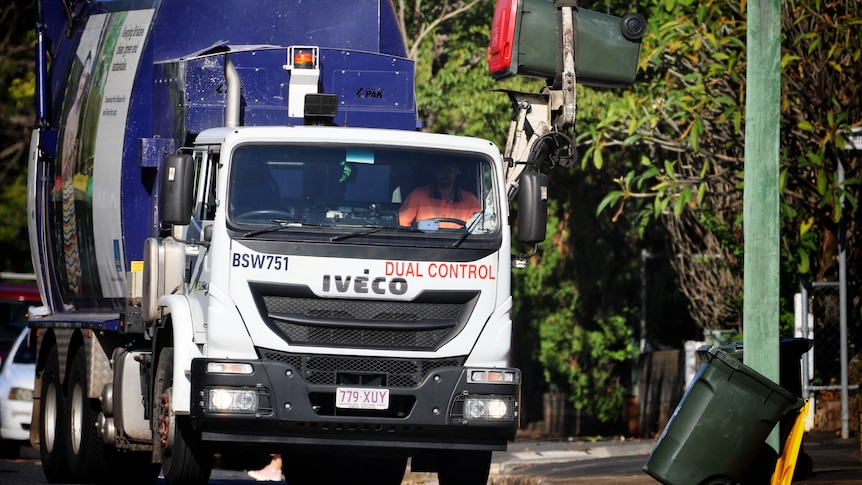 A Brisbane City Council rubbish truck picking up a bin.