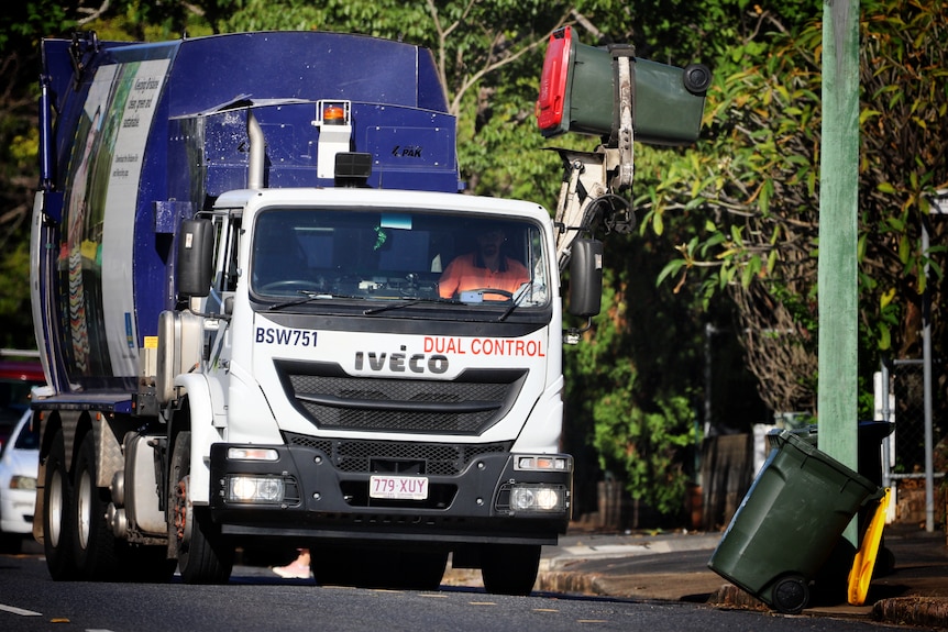 A Brisbane City Council rubbish truck picking up a bin.