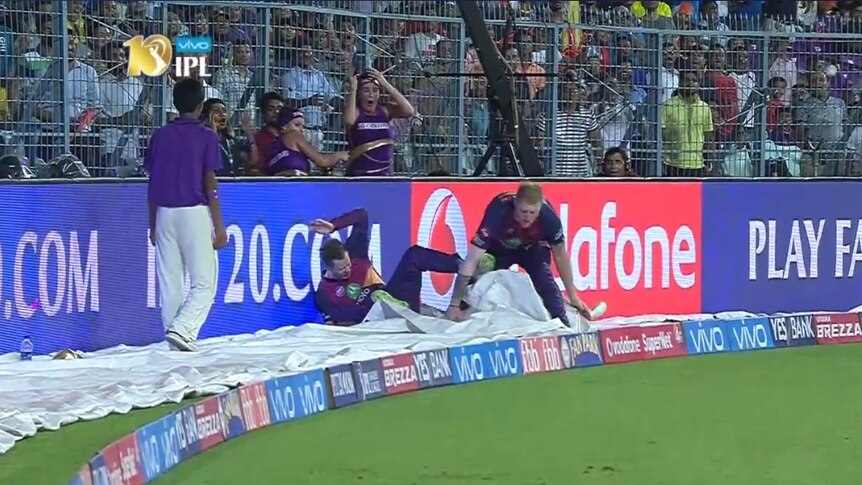 Steve Smith hits the advertising board after colliding with Ben Stokes