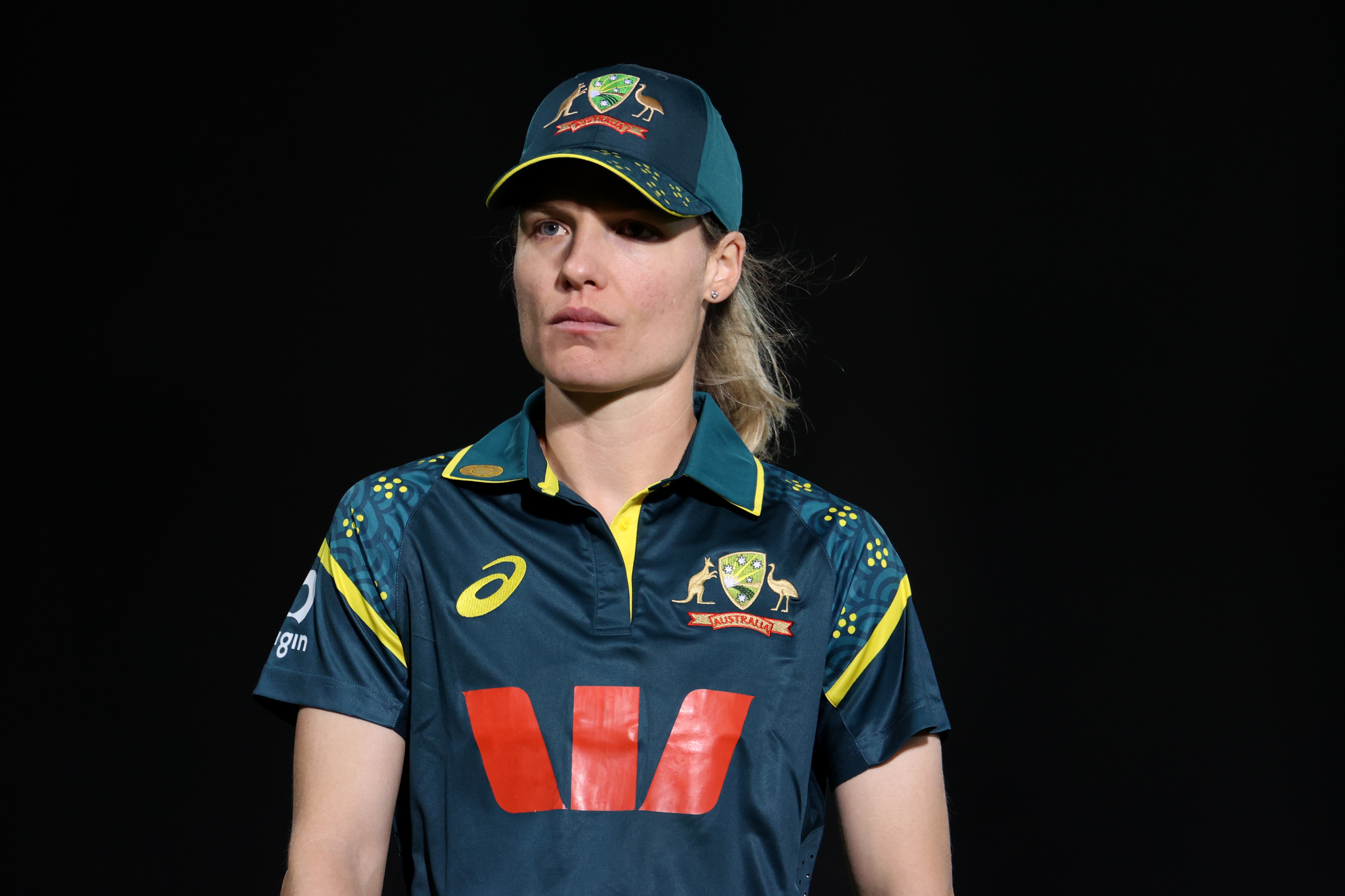 Australian cricketer Nicola Carey looks pensive during a game when she's fielding.