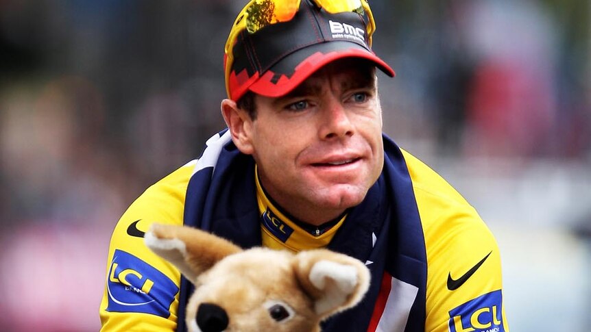 Cadel Evans takes part in a victory parade on the Champs-Elysees