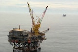 Aerial shot of an oil rig in the ocean.
