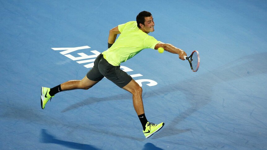 Bernard Tomic stretches for the ball at the Sydney International