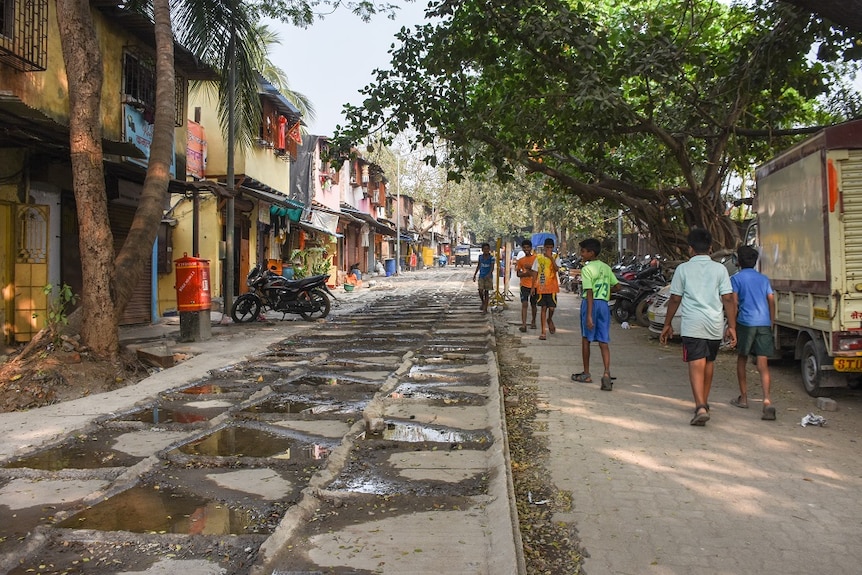 A wide street with people walking down it