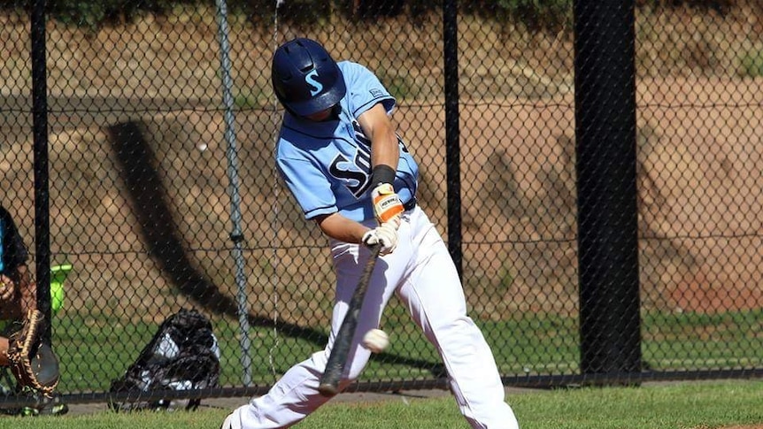 A baseball player is about to hit the ball