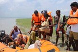 Members of India's National Disaster Response Force evacuate villagers in Supaul district in the eastern Indian state of Bihar.