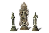 One large antique bronze statue in between two smaller ones.