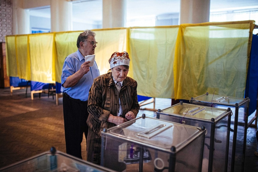 A man and woman cast their ballots