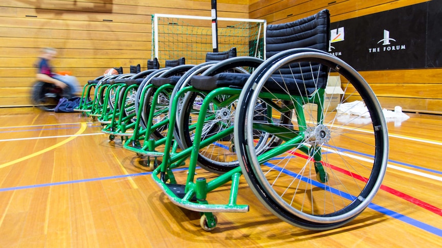Wheelchairs sit in a line.