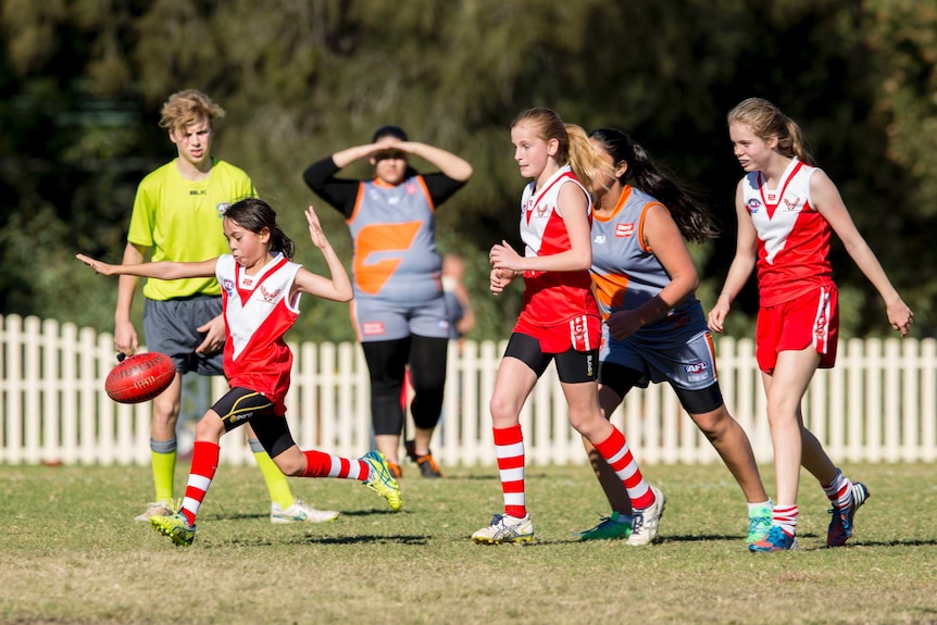 A young player from the Newton-Glebe Breakers kicks