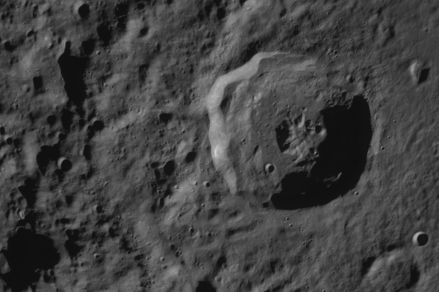 A black and white image of a moon crater