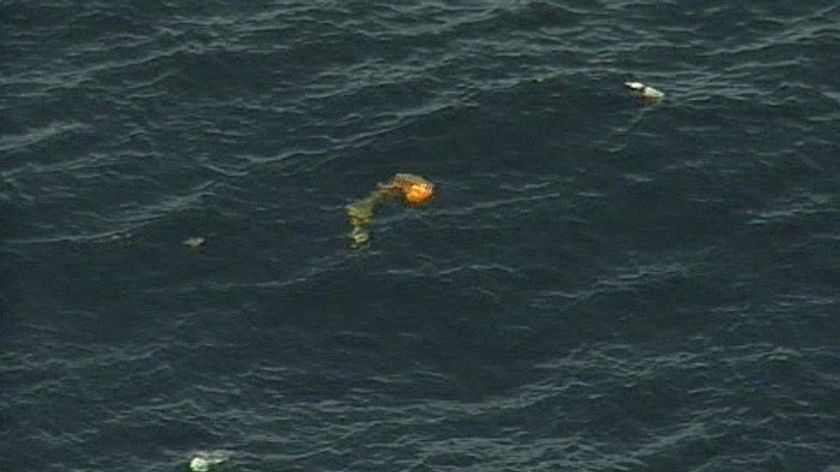 Debris from an 18-seater metro plane lies strewn in the ocean
