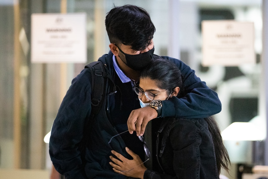 Couple hug and cry at the airport after WA border reopening
