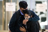 Couple hug and cry at the airport after WA border reopening