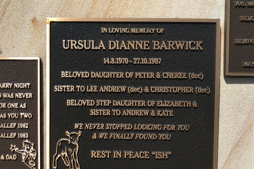 A photo of a cemetery plaque