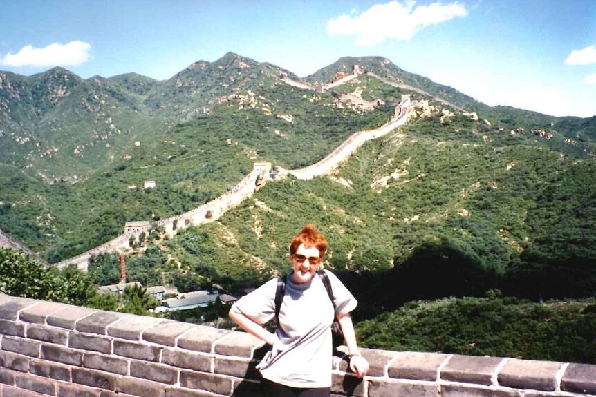 Jackie May stands atop the Great Wall of China in 1995.