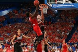 Perth Wildcats' Casey Prather (L) lays up against Andrew Ogilvy of the Illawarra Hawks.