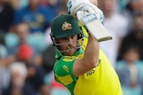 Aaron Finch, leaning forward onto his front foot, holds his straight bat at eye level. The ball has come off it.