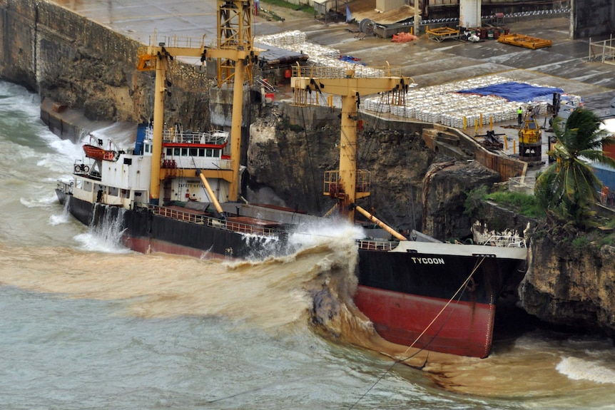 Waves crash over the stricken phosphate ship the MV Tycoon