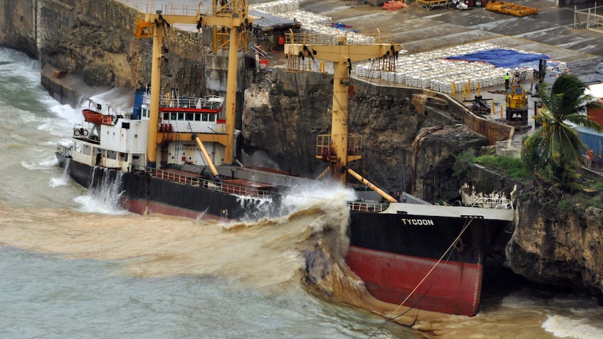 Waves crash over the stricken phosphate ship the MV Tycoon