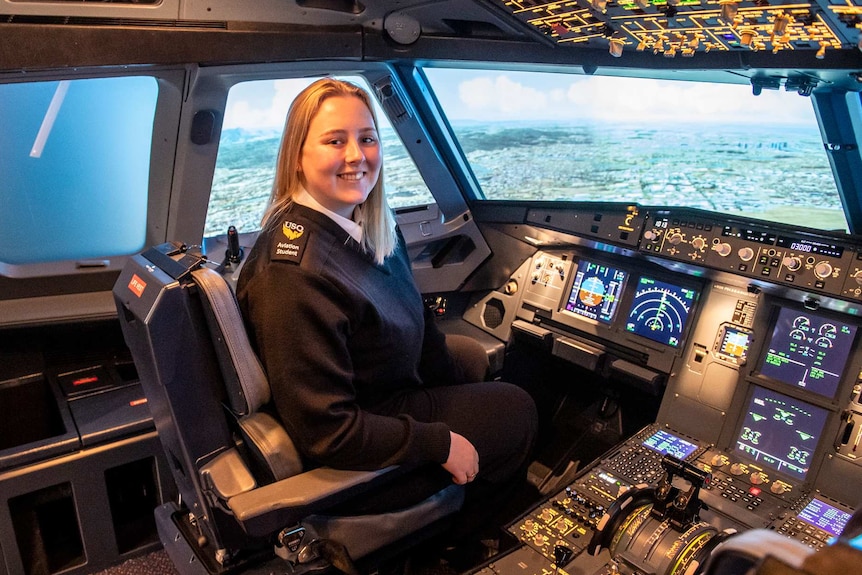 an aviation student sits in a flight simulator