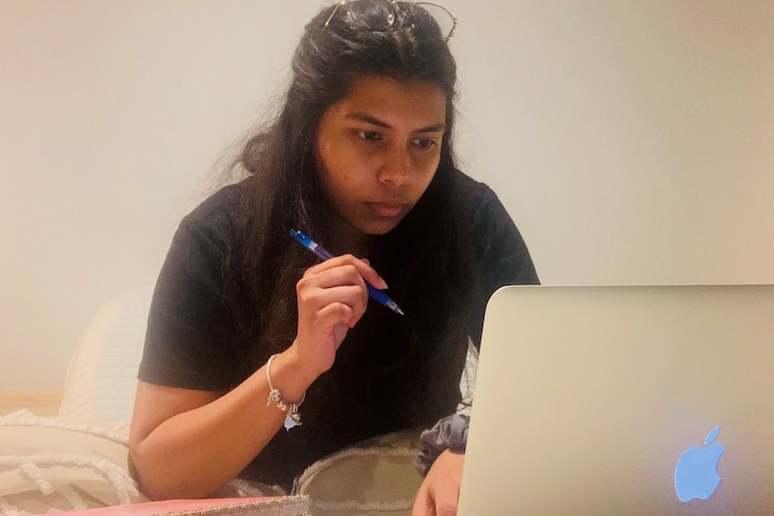 a young woman at a computer studying
