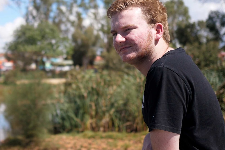 An 18-year-old man Josh Cording standing at a fence overlooking a lake in Northam.