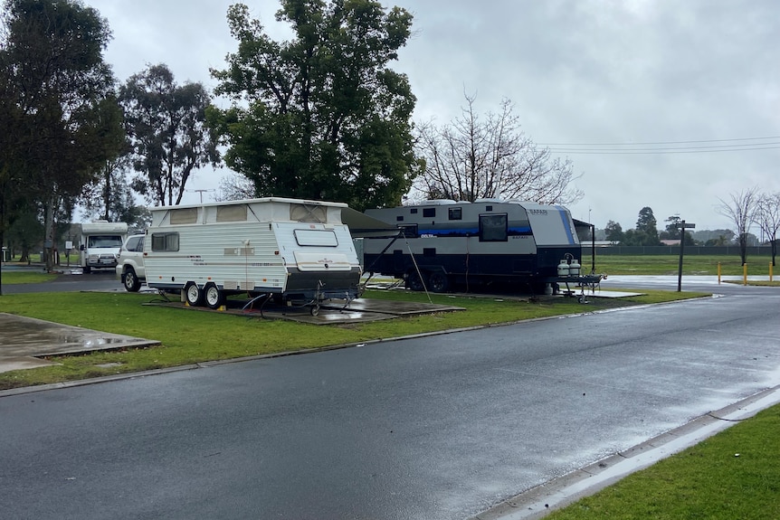 A photo of two caravans on caravan park site 