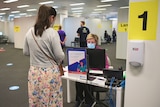 Woman checks in for a COVID-19 vaccination at Ipswich hub, west of Brisbane on October 6, 2021.