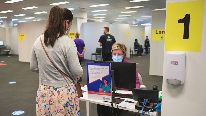 Woman checks in for a COVID-19 vaccination 