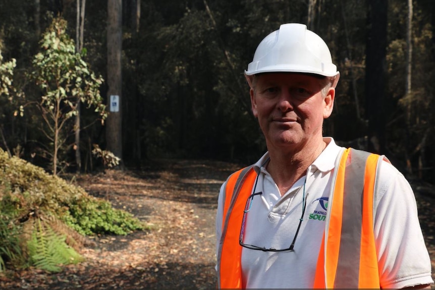 Ken Stronach owner of the Tahune Airwalk on site in a hard hat and hi-vis vest.