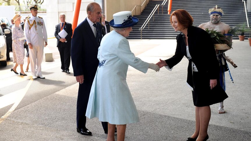 The Queen and Prince Philip are welcomed by Julia Gillard outside CHOGM