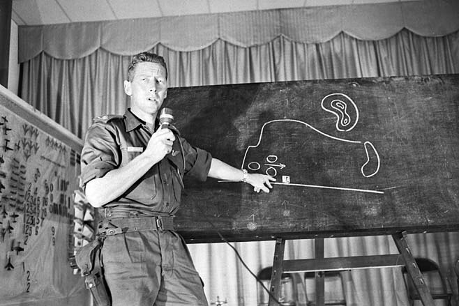 Harry Smith at a blackboard explaining what happened during the Battle of Long Tan.