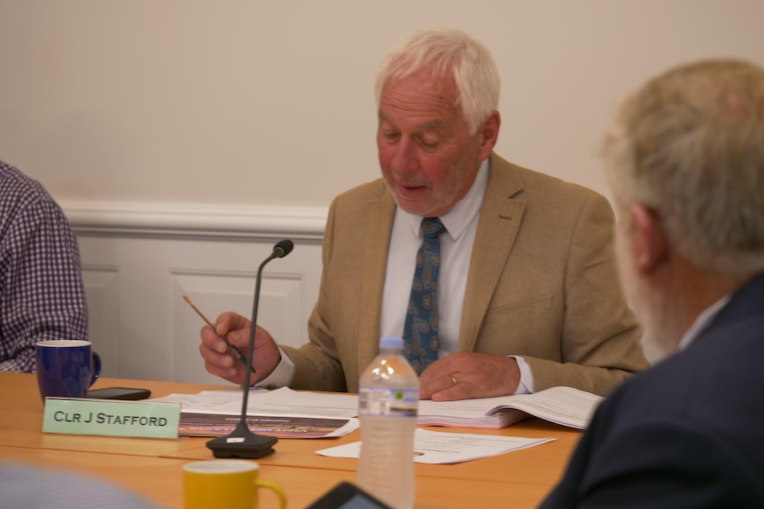 A man chairing a council meeting