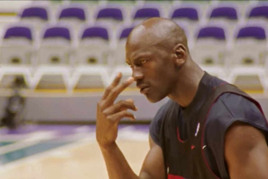 Michael Jordan points to his eyes during a Chicago Bulls training session.