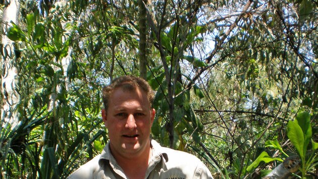 Tasmania Zoo operations manager Robert Warren holds a crocodile.