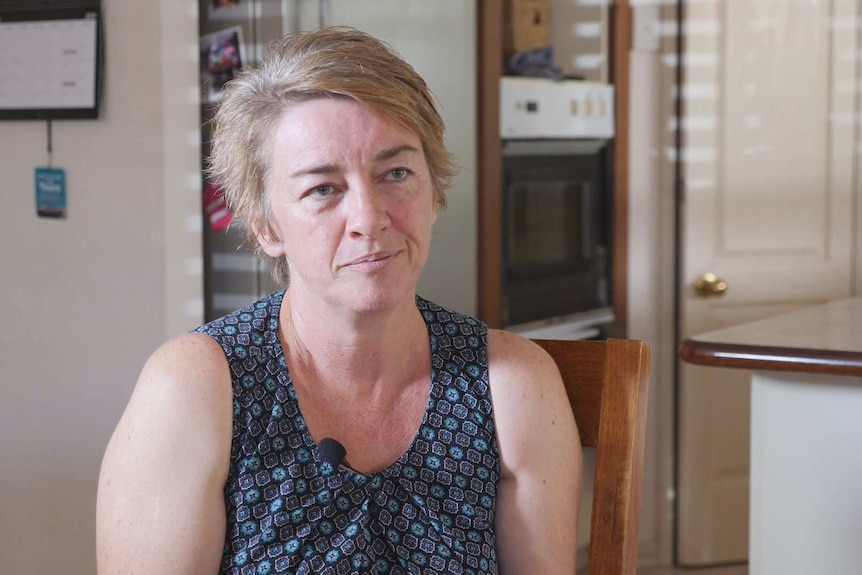 Andrea Anthony sits at her kitchen bench.