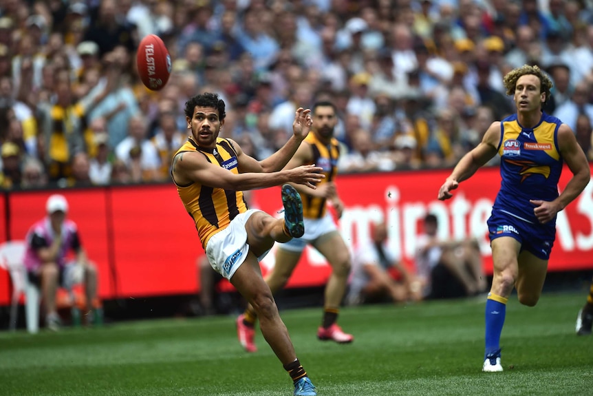 Hawthorn's Cyril Rioli kicks his team's first goal against West Coast in the 2015 AFL grand final.