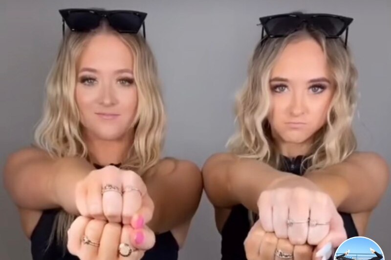 Two girls doing dance moves on social media.