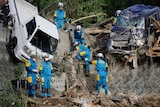 Rescuers search for missing people at a mudslide site
