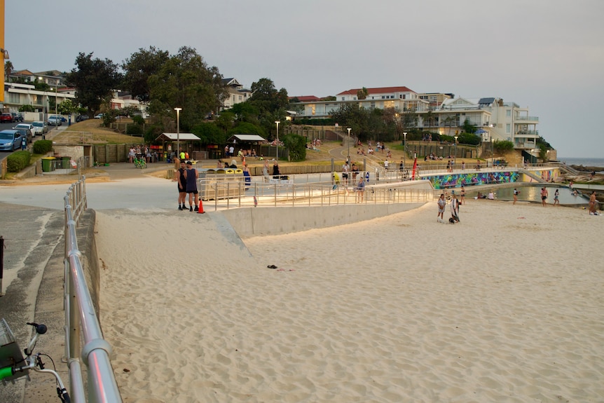 Two access ramps at Bondi Beach with no beach matting and full of sand, impossible for wheelchairs
