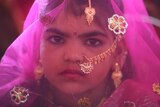 An Indian girl from the Saraniya community dressed up in pink veil for her engagement ceremony.
